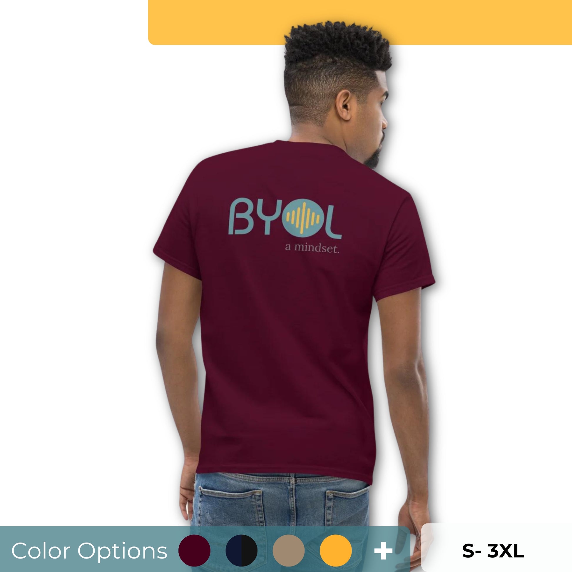 A young man with short hair wearing a maroon "BYOL: a mindset" T-shirt, viewed from the back. The T-shirt features the "BYOL" logo in teal and yellow on the back and is available in multiple colors (maroon, black, brown, gold, plus more) and sizes (S-3XL). The "be you out loud" logo is displayed at the top.