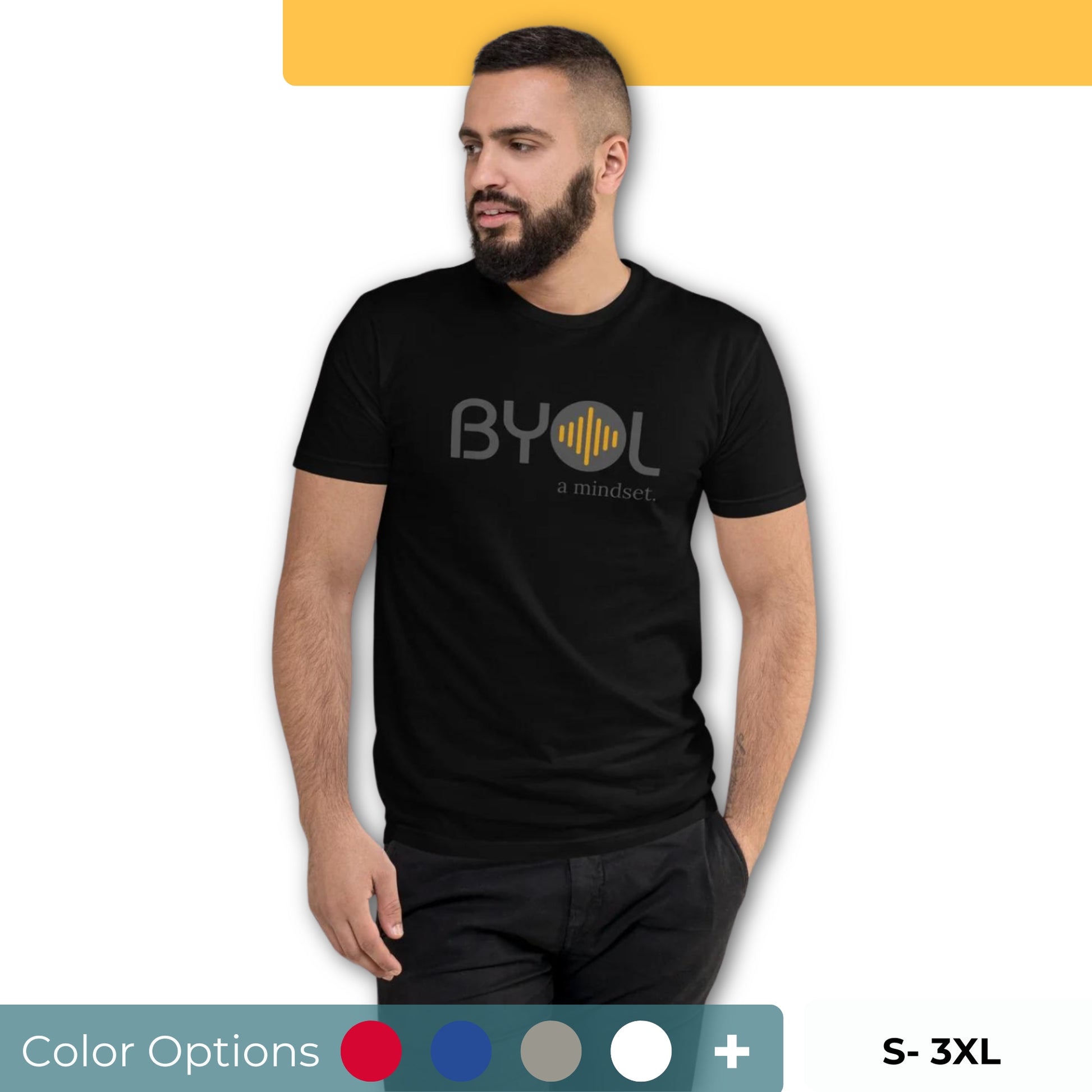 A young man with short dark hair and a beard wearing a black "BYOL: a mindset" T-shirt, standing with one hand in his pocket and looking to the side. The T-shirt features the "BYOL" logo in gray and yellow on the front and is available in multiple colors (red, blue, gray, plus more) and sizes (S-3XL). The "be you out loud" logo is displayed at the top.