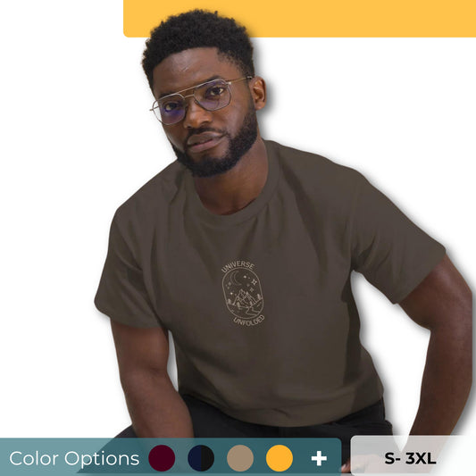 Man in a chocolate tee with a cosmic design saying 'Universe Unfolded', epitomizing bold self-expression showing the color options and size options .