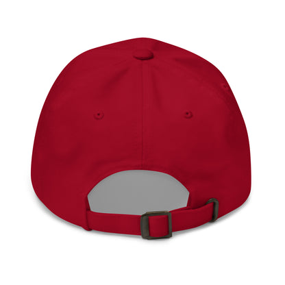 The back of a red dad hat features an adjustable strap with a metal buckle for sizing.