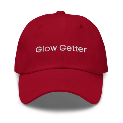 Red baseball cap with white embroidered text 'Glow Getter' on the front.