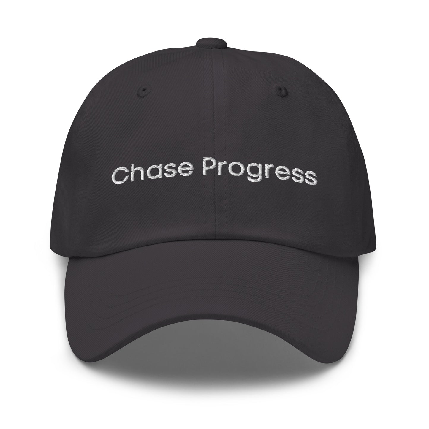 A dark grey dad hat with the phrase "Chase Progress" embroidered in white stitching across the front.