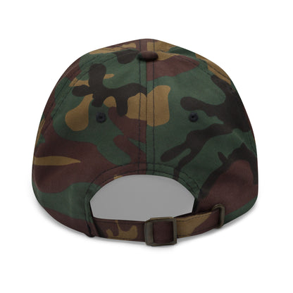 The back of a camo dad hat features an adjustable strap with a metal buckle for sizing.