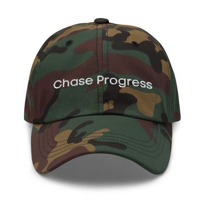 A chamo dad hat with the phrase "Chase Progress" embroidered in white stitching across the front.