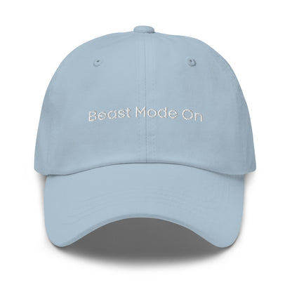 A light blue dad hat with the phrase "Beast Mode On" embroidered in white stitching across the front.