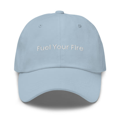 Light blue baseball cap with the words "Fuel Your Fire" embroidered in white on the front. The brim is slightly curved. Text "Dad Hat" is written above the image.