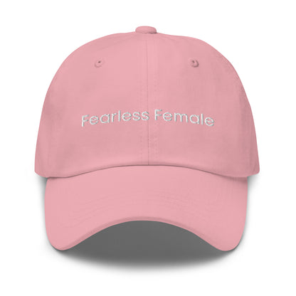 A pink dad hat with the phrase "Fearless Female" embroidered in white stitching across the front.