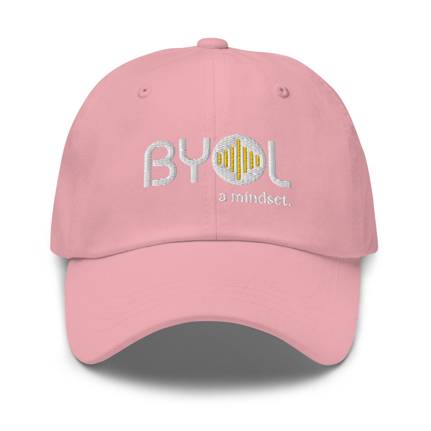 Pink classic dad hat with "BYOL a mindset" embroidered on the front in white and yellow, displayed against a clean background. Available in various colors: black, gray, green, pink, and tan.