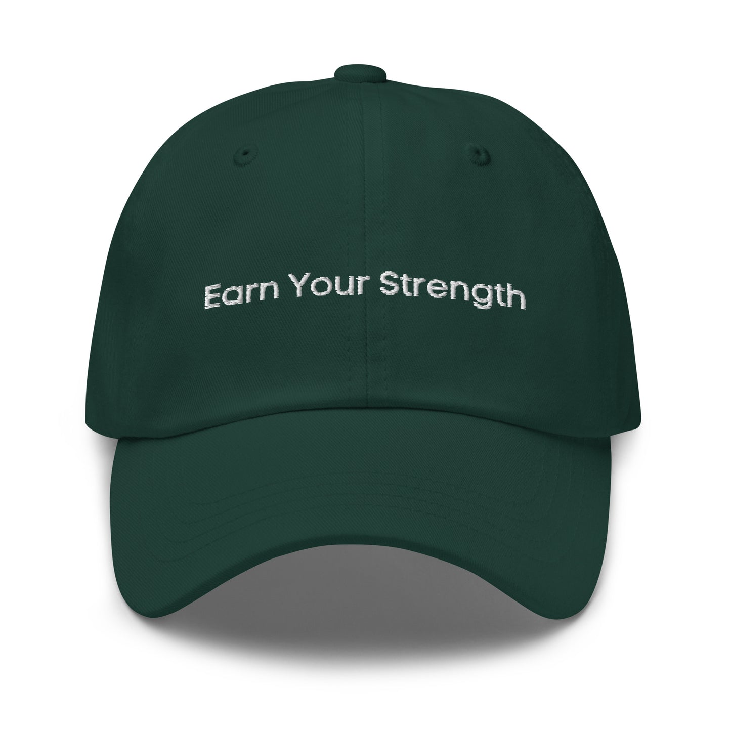 A dark green dad hat with the phrase "Earn Your Strength" embroidered in white stitching across the front.