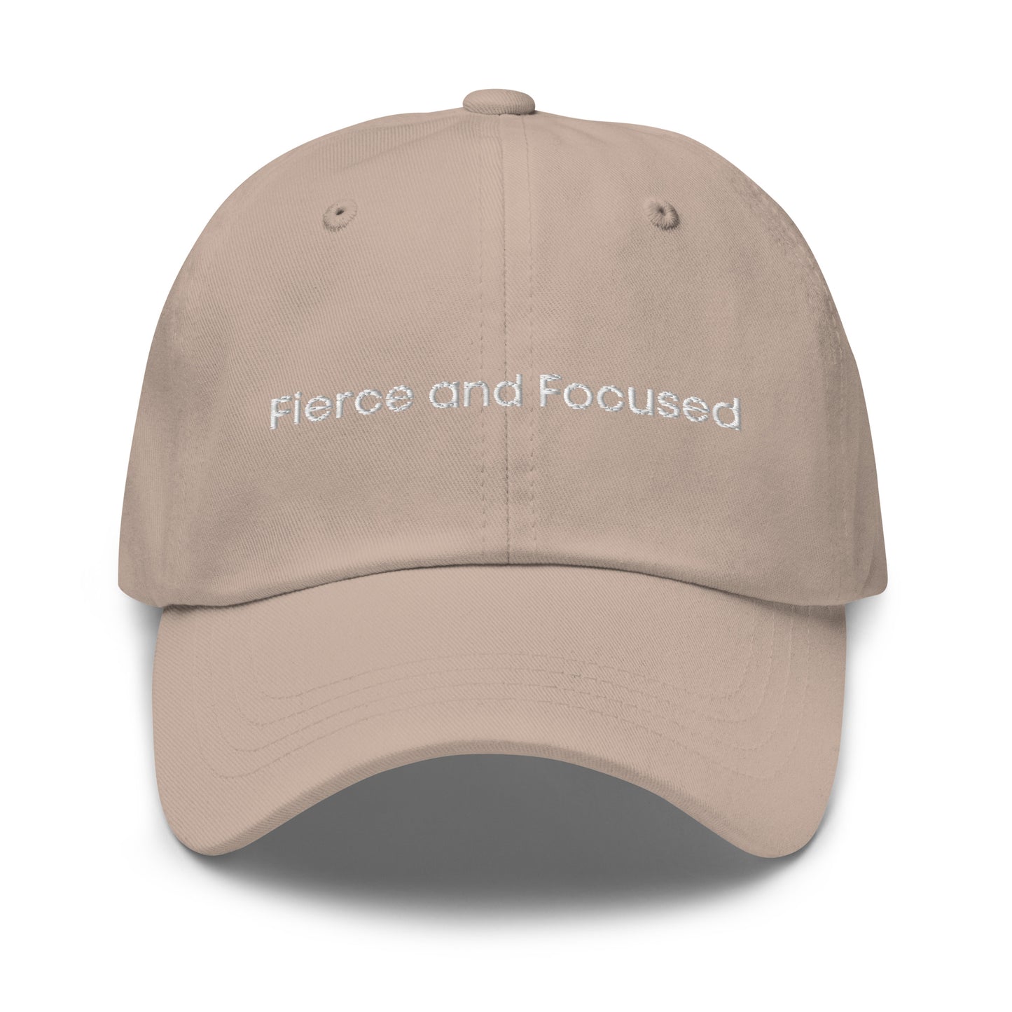 A stone dad hat with the phrase "Fierce and Focused" embroidered in white stitching across the front.