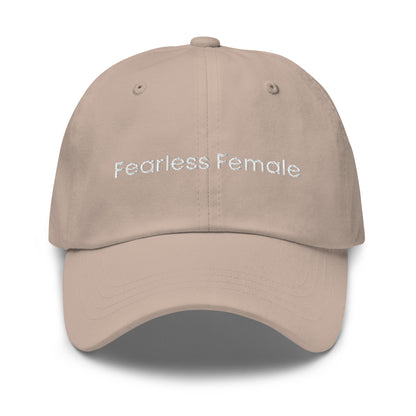 A stone dad hat with the phrase "Fearless Female" embroidered in white stitching across the front.