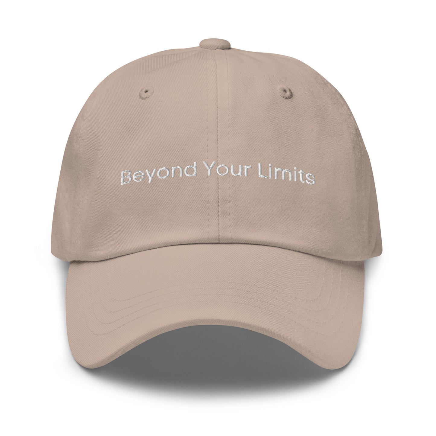 A stone dad hat with the phrase "Beyond Your Limits" embroidered in white stitching across the front.