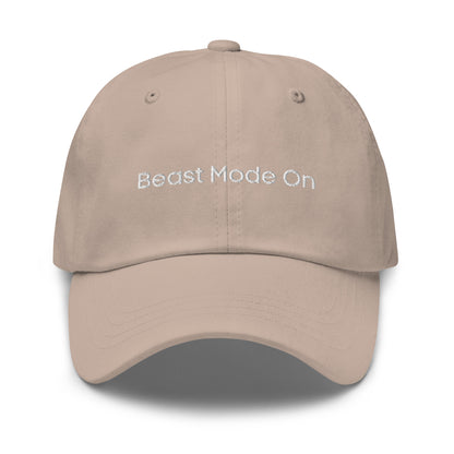 A stone dad hat with the phrase "Beast Mode On" embroidered in white stitching across the front.