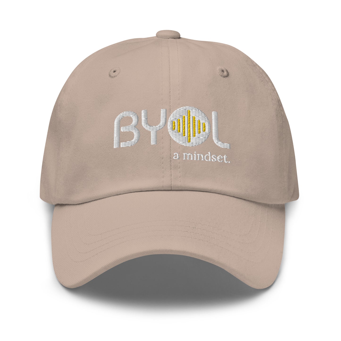 Tan classic dad hat with "BYOL a mindset" embroidered on the front in white and yellow, displayed against a clean background. Available in various colors: black, gray, green, pink, and tan.