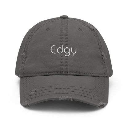 A front view of a grey distressed baseball cap with the word "Edgy" embroidered in white on the front panel, featuring a frayed brim and distressed details for a worn, stylish look.