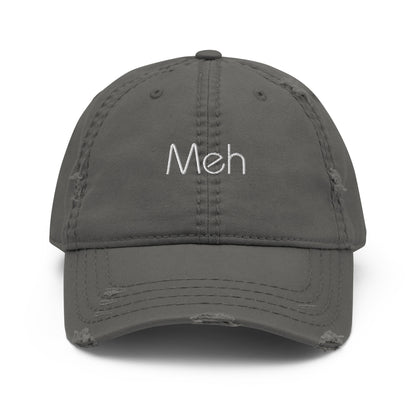 A Grey dad hat with a slightly distressed brim and crown, featuring the word "Meh" embroidered in white on the front.