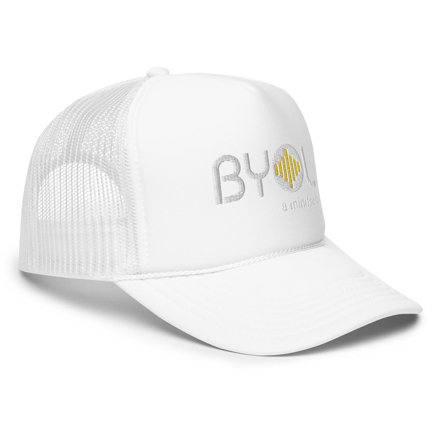 Side of white foam trucker hat with "BYOL a mindset" embroidered on the front in white and yellow, featuring a black mesh back, displayed against a clean background. Available in various colors: black, white and blue, blue, pink, and white.