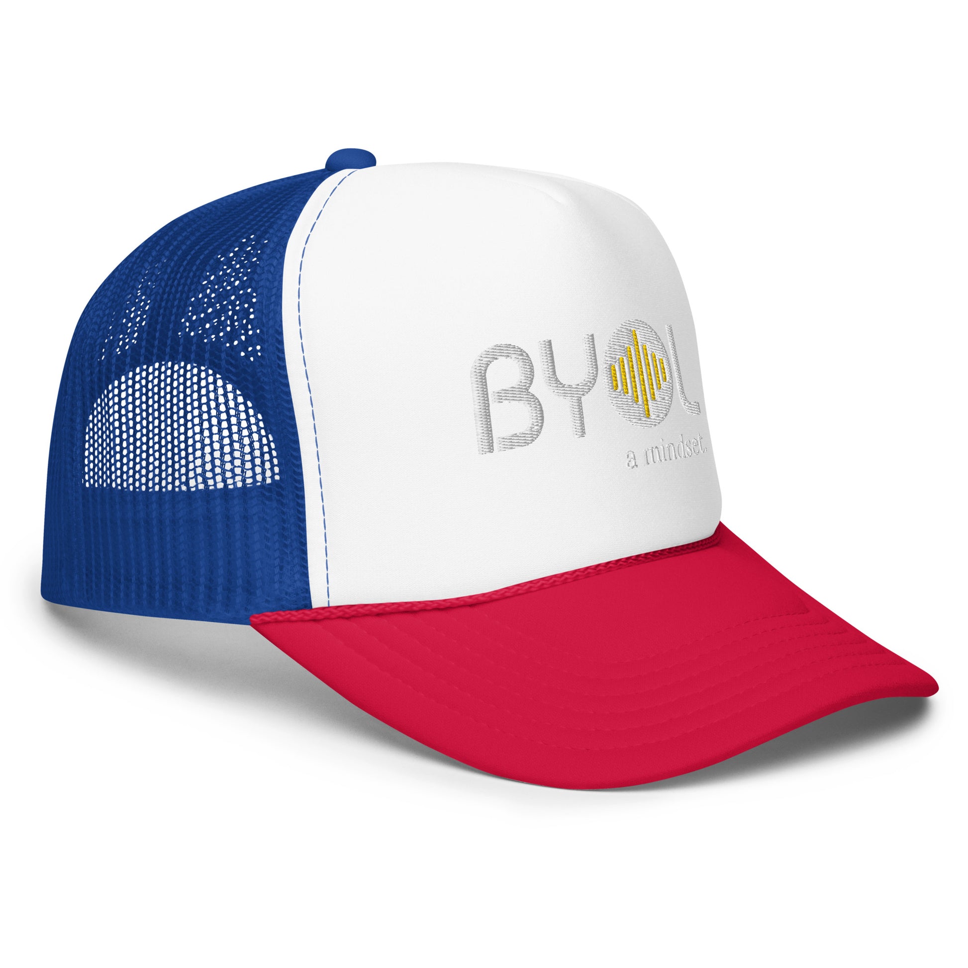 Side of white, red, and blue foam trucker hat with "BYOL a mindset" embroidered on the front in white and yellow, featuring a black mesh back, displayed against a clean background. Available in various colors: black, white and blue, blue, pink, and white.