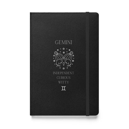 Black hardcover notebook with the word "Gemini" and an image of two women facing eachother with a list of three characteristics and the gemini zodiac sign