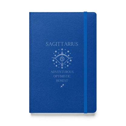 A blue hardbound notebook with the word "Sagittarius" at the top and the image of a bow, as well as three characteristics and the zodiac sign