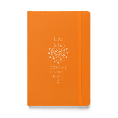 Orange hardcover notebook with the word "low" on top, then an image of a lion followed by three different leo traits and the leo zodiac sign. 