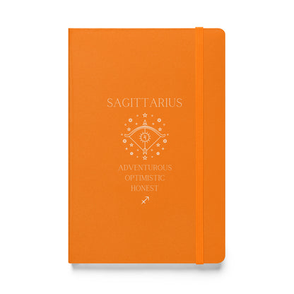 A orange hardbound notebook with the word "Sagittarius" at the top and the image of a bow, as well as three characteristics and the zodiac sign