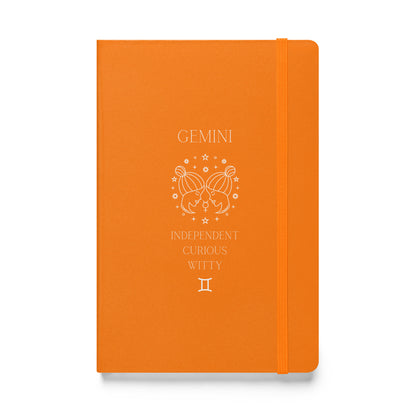 Orange hardcover notebook with the word "Gemini" and an image of two women facing eachother with a list of three characteristics and the gemini zodiac sign