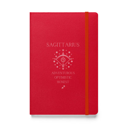 A red hardbound notebook with the word "Sagittarius" at the top and the image of a bow, as well as three characteristics and the zodiac sign