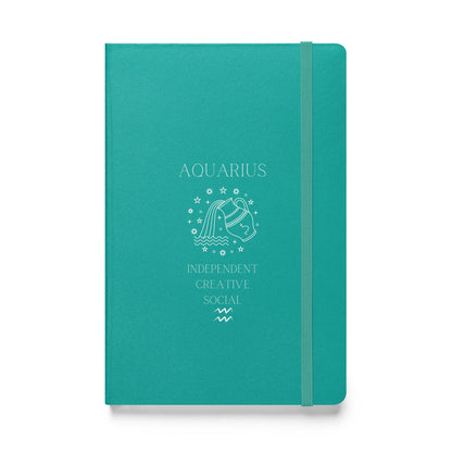 A turqoise hardcover notebook with 'AQUARIUS' and symbolic illustrations printed in white, along with the words 'INDEPENDENT CREATIVE SOCIAL'. The notebook features an elastic closure.