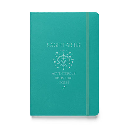 A turquoise hardbound notebook with the word "Sagittarius" at the top and the image of a bow, as well as three characteristics and the zodiac sign