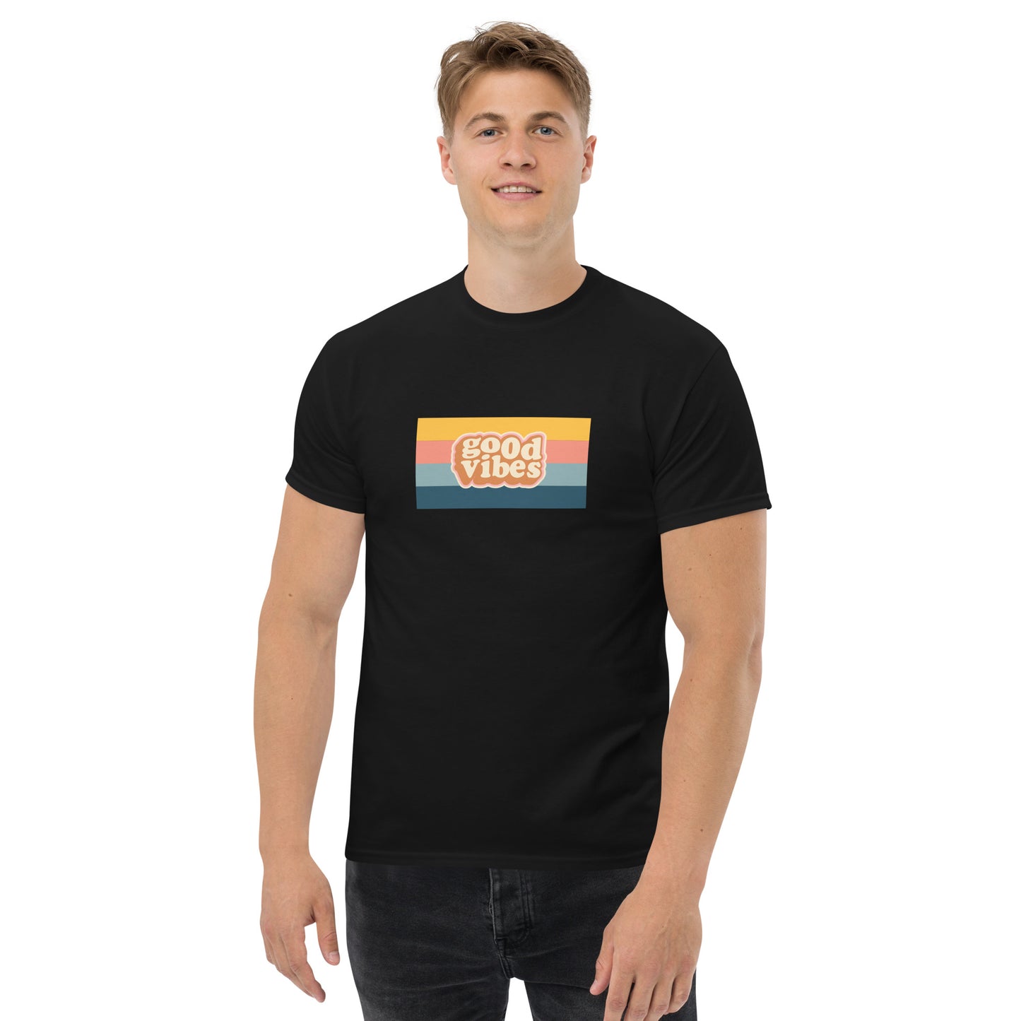 Smiling man wearing a black classic tee with a colorful 'good vibes' retro graphic, symbolizing relaxed and inspirational personal style.