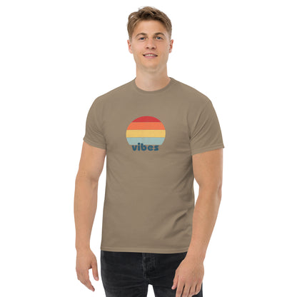 Confident man sporting a savana brown classic tee with a colorful retro sunset design and 'vibes' text, evoking a relaxed and inspiring mood.