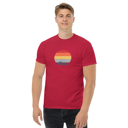 Confident man sporting a cardinal red classic tee with a colorful retro sunset design and 'vibes' text, evoking a relaxed and inspiring mood.