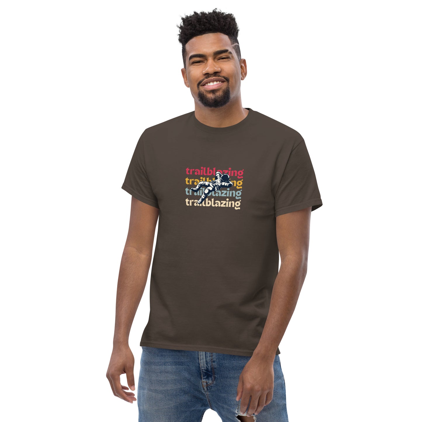 Smiling man in a dark chocolate classic tee with vibrant 'trailblazing' text, embodying the spirit of boldness and individual trailblazing attitude.