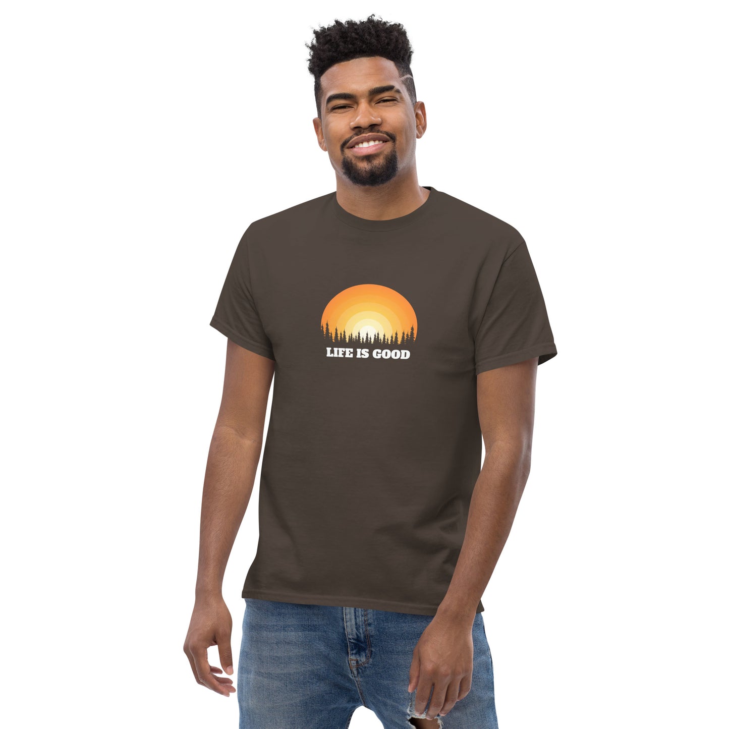 Happy man wearing a chocolate brown classic tee with a vibrant sunset graphic and 'Life Is Good' slogan, inspiring positivity and joy.