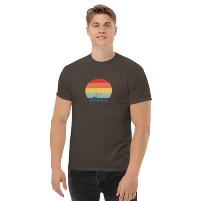 Confident man sporting a chocolate brown classic tee with a colorful retro sunset design and 'vibes' text, evoking a relaxed and inspiring mood.