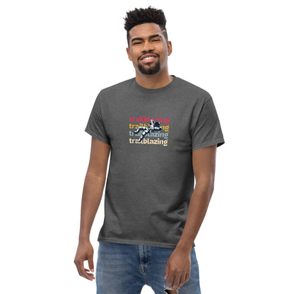 Smiling man in a heather grey classic tee with vibrant 'trailblazing' text, embodying the spirit of boldness and individual trailblazing attitude.