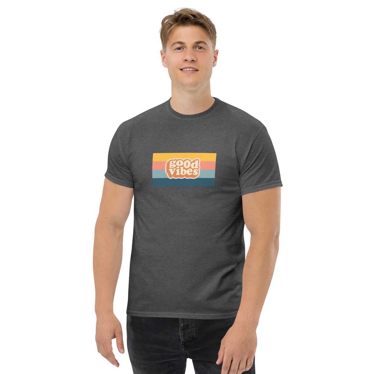 Smiling man wearing a heather grey classic tee with a colorful 'good vibes' retro graphic, symbolizing relaxed and inspirational personal style.