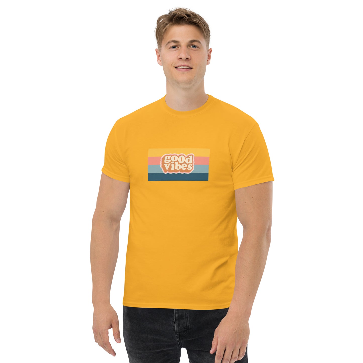 Smiling man wearing a yellow classic tee with a colorful 'good vibes' retro graphic, symbolizing relaxed and inspirational personal style.