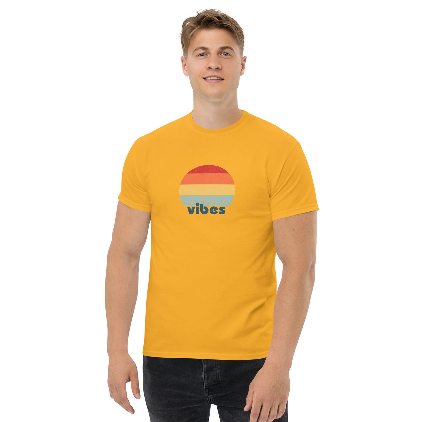 Confident man sporting a yellow classic tee with a colorful retro sunset design and 'vibes' text, evoking a relaxed and inspiring mood.