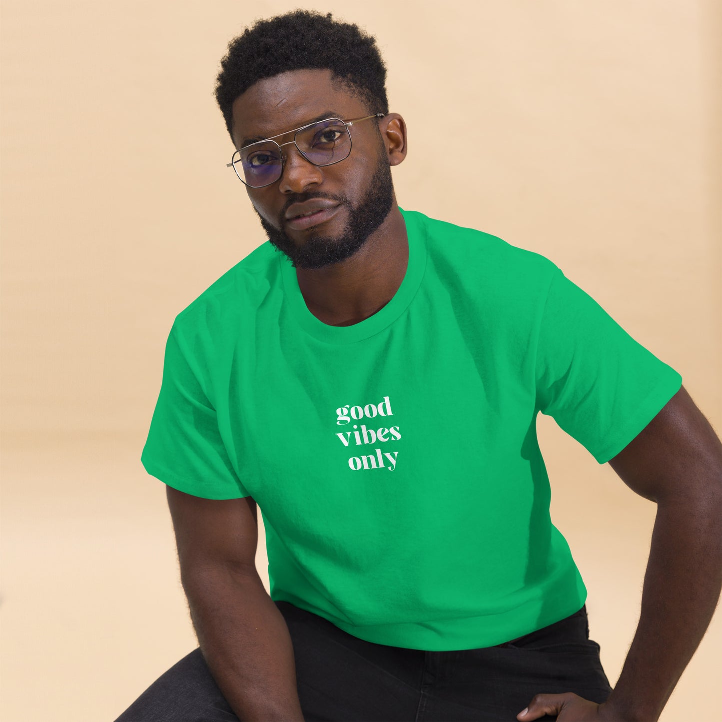 Man wearing a irish green classic tee with 'good vibes only' text, a testament to a lifestyle of positivity and authentic personal expression.