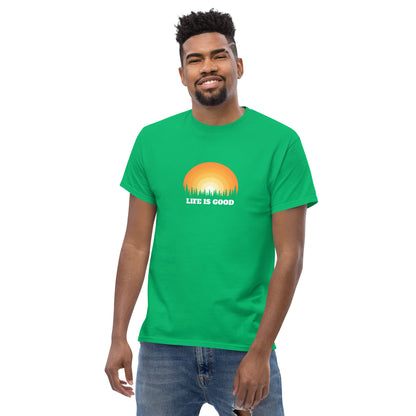 Happy man wearing a irish green classic tee with a vibrant sunset graphic and 'Life Is Good' slogan, inspiring positivity and joy.