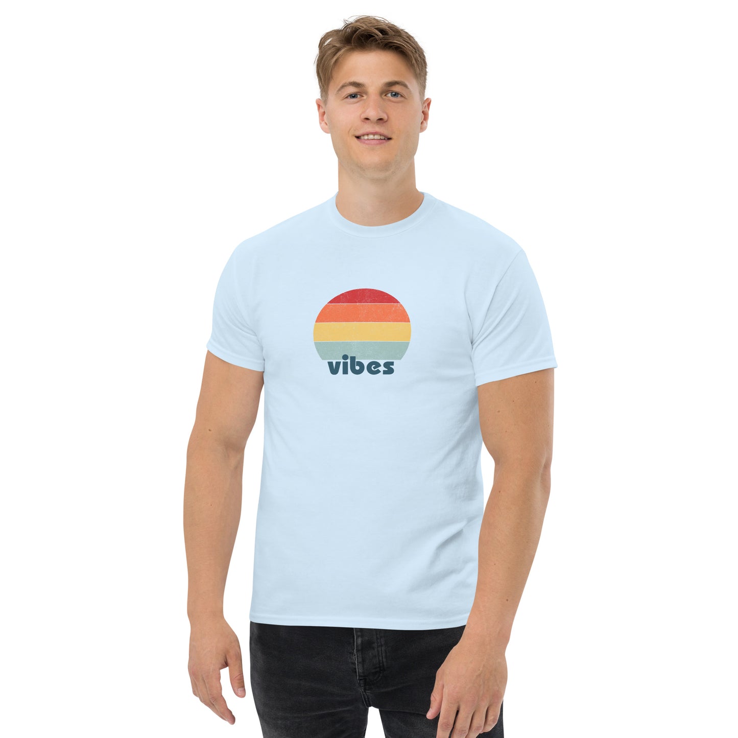 Confident man sporting a carolina blue classic tee with a colorful retro sunset design and 'vibes' text, evoking a relaxed and inspiring mood.