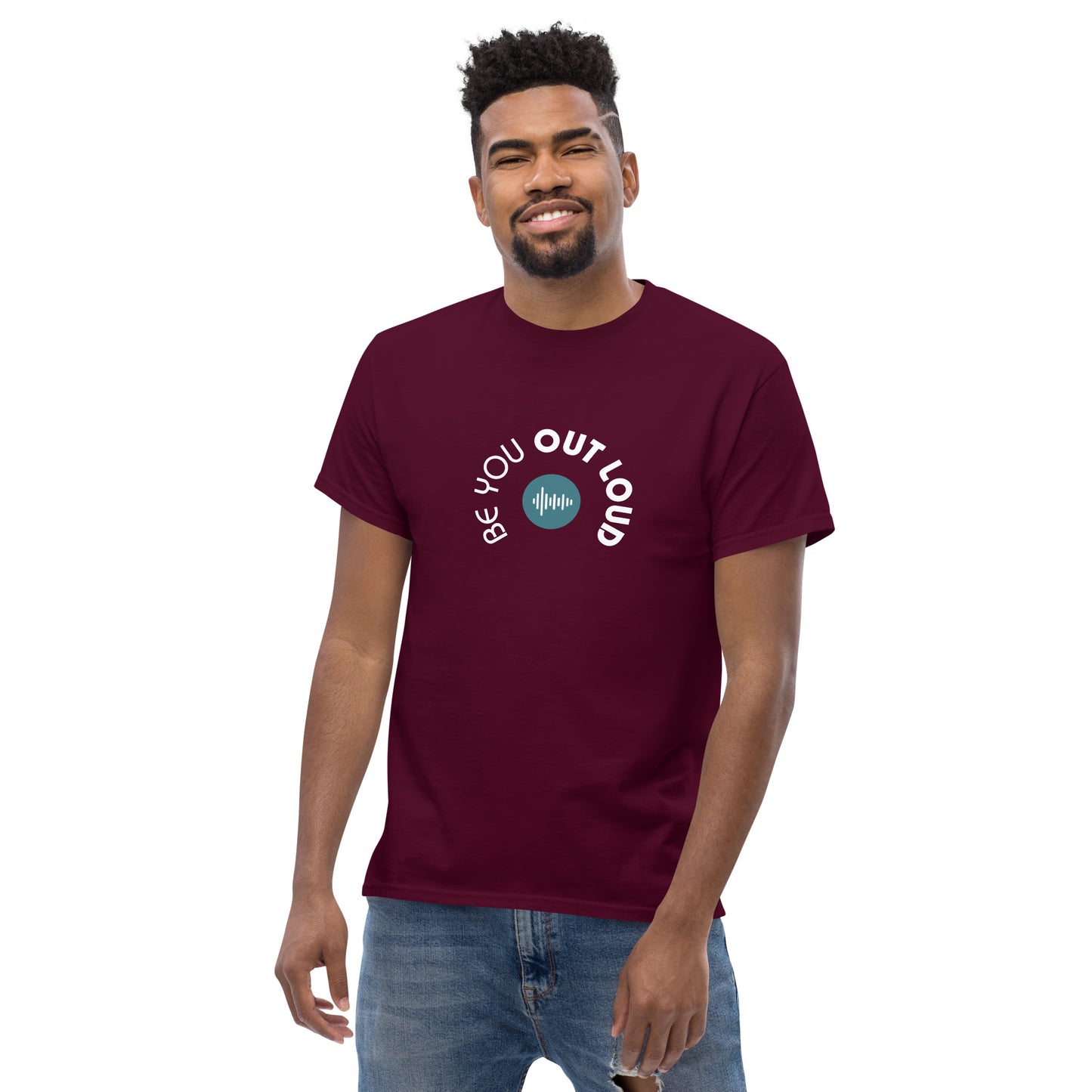 Man smiling in a maroon classic tee featuring the 'Be You Out Loud' white and blue logo on the front