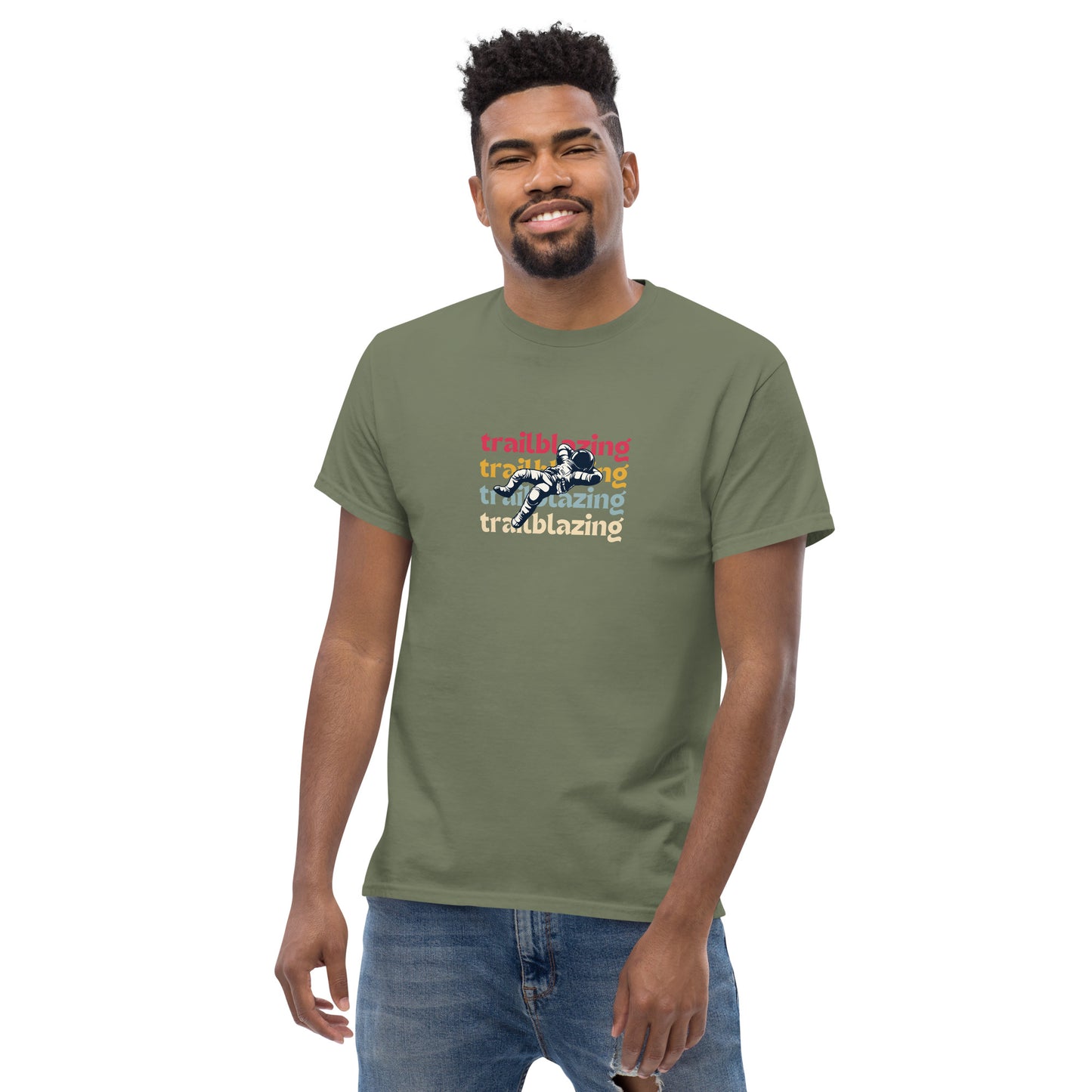 Smiling man in a military green classic tee with vibrant 'trailblazing' text, embodying the spirit of boldness and individual trailblazing attitude.