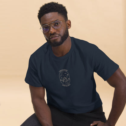 Man in a navy blue tee with a cosmic design saying 'Universe Unfolded', epitomizing bold self-expression.