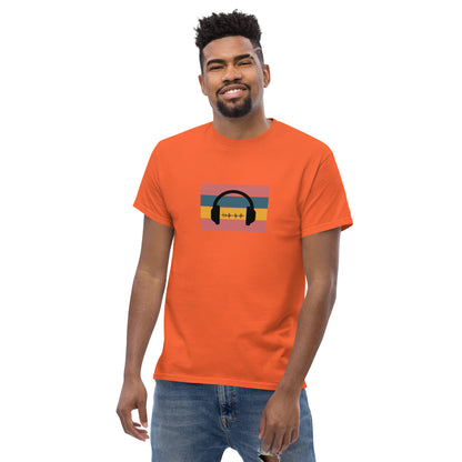 Man smiling in a orange classic tee featuring a sunset and skyline design with 'Life Is Good' text, symbolizing optimism and bold living.