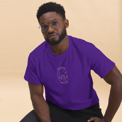 Man in a purple tee with a cosmic design saying 'Universe Unfolded', epitomizing bold self-expression.