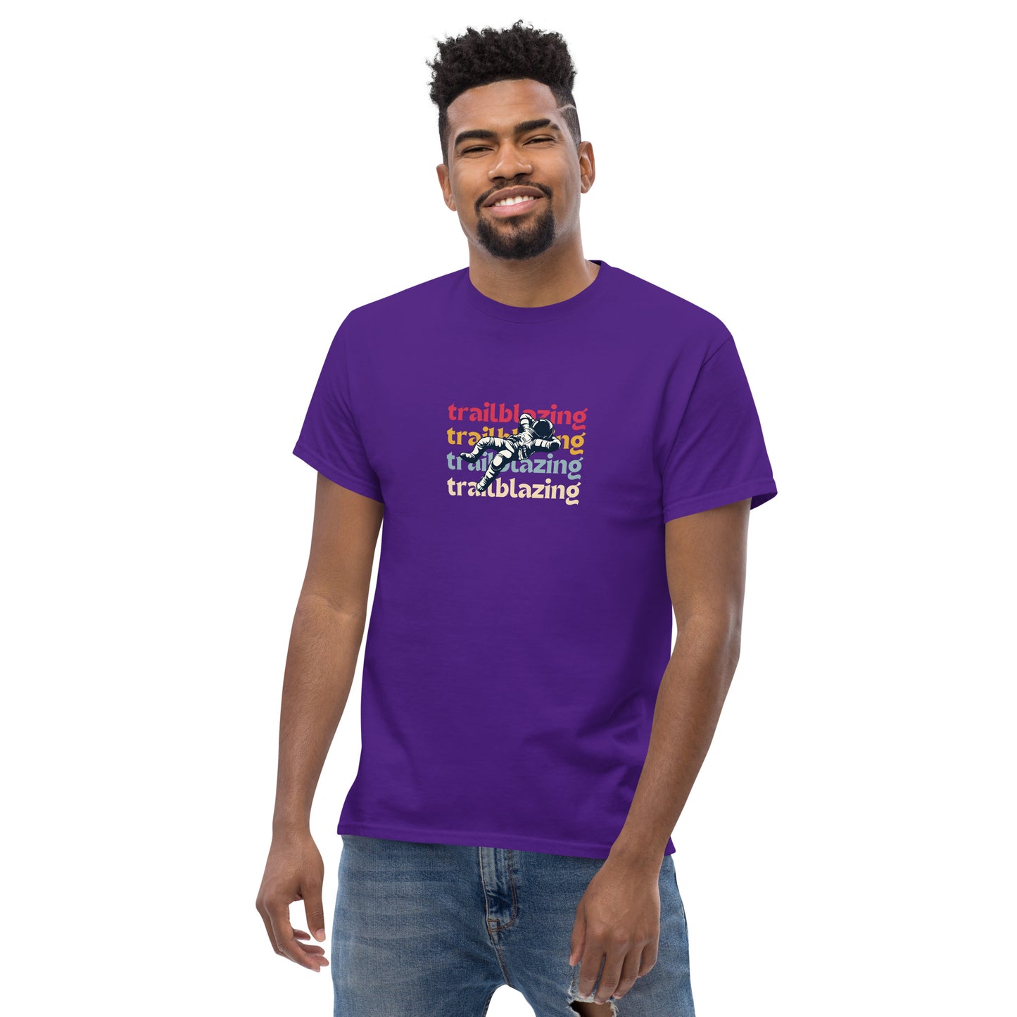 Smiling man in a purple classic tee with vibrant 'trailblazing' text, embodying the spirit of boldness and individual trailblazing attitude.