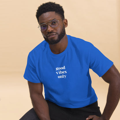 Man wearing a royal blue classic tee with 'good vibes only' text, a testament to a lifestyle of positivity and authentic personal expression.